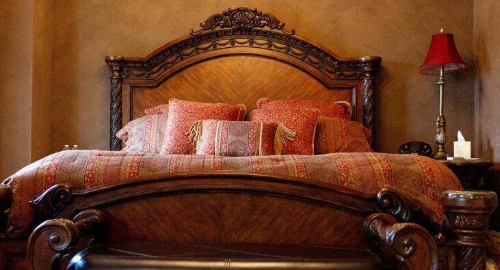 bed in Belle Room with red and brown linens
